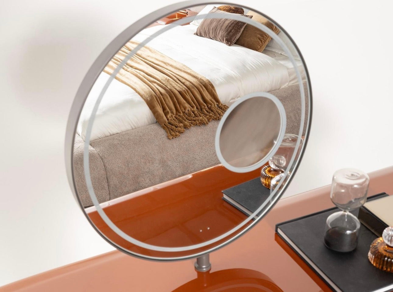 Urbane modern luxury furniture collection featuring sculptural dining table, curved bedroom furniture, and terracotta lacquer accents.