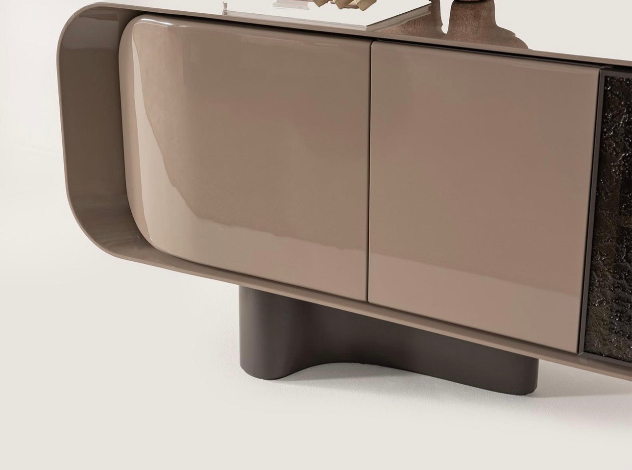 Urbane modern luxury furniture collection featuring sculptural dining table, curved bedroom furniture, and terracotta lacquer accents.