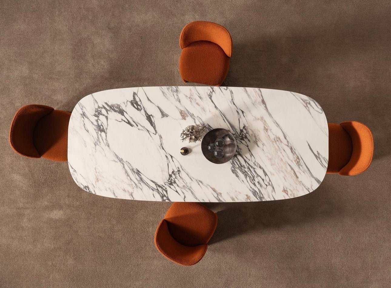 Urbane modern luxury furniture collection featuring sculptural dining table, curved bedroom furniture, and terracotta lacquer accents.