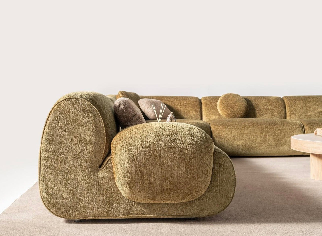 Lumen modern organic living room collection with curved sectional sofa, natural wood coffee tables, and warm minimalist interior design.