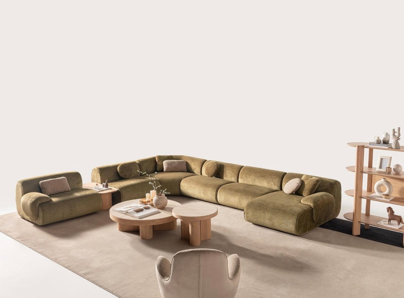 Lumen modern organic living room collection with curved sectional sofa, natural wood coffee tables, and warm minimalist interior design.