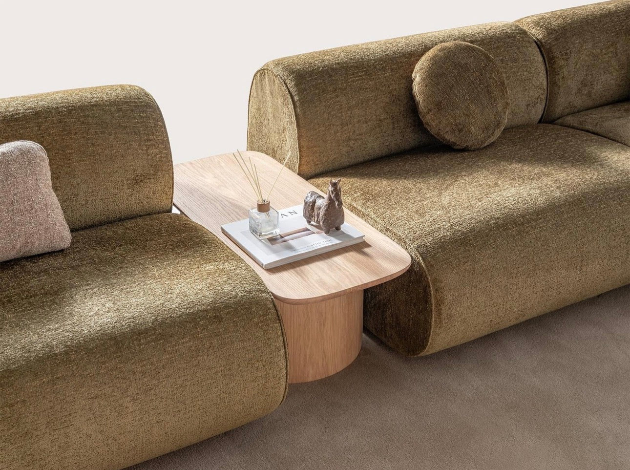 Lumen modern organic living room collection with curved sectional sofa, natural wood coffee tables, and warm minimalist interior design.