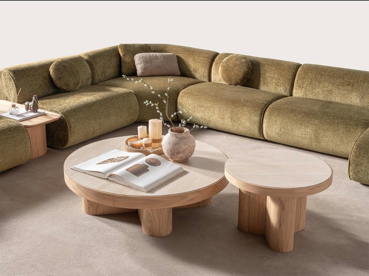 Lumen modern organic living room collection with curved sectional sofa, natural wood coffee tables, and warm minimalist interior design.