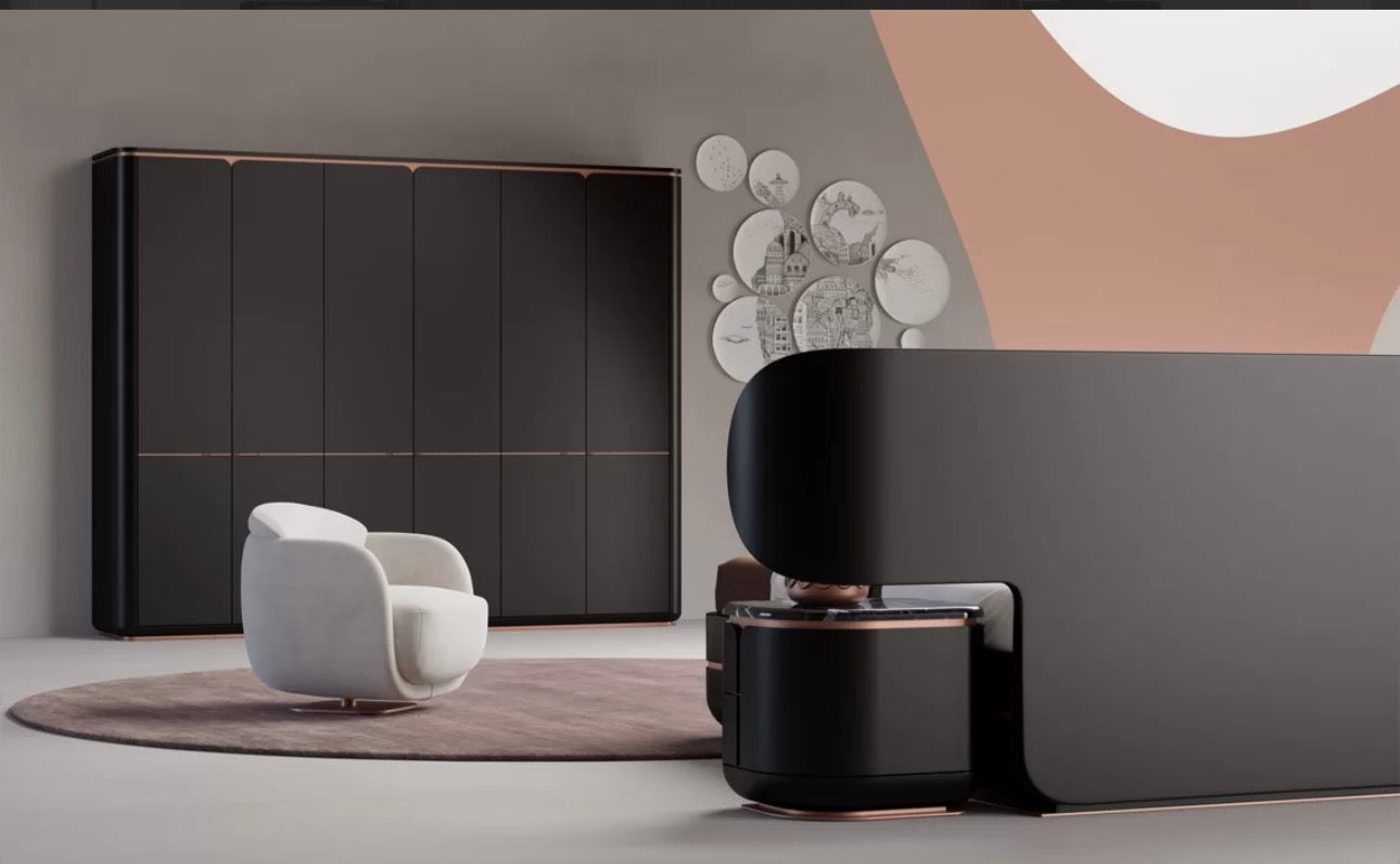 Petale luxury bedroom furniture collection with curved upholstered bed, sculptural nightstands, and dark lacquer wardrobe with rose-gold accents.