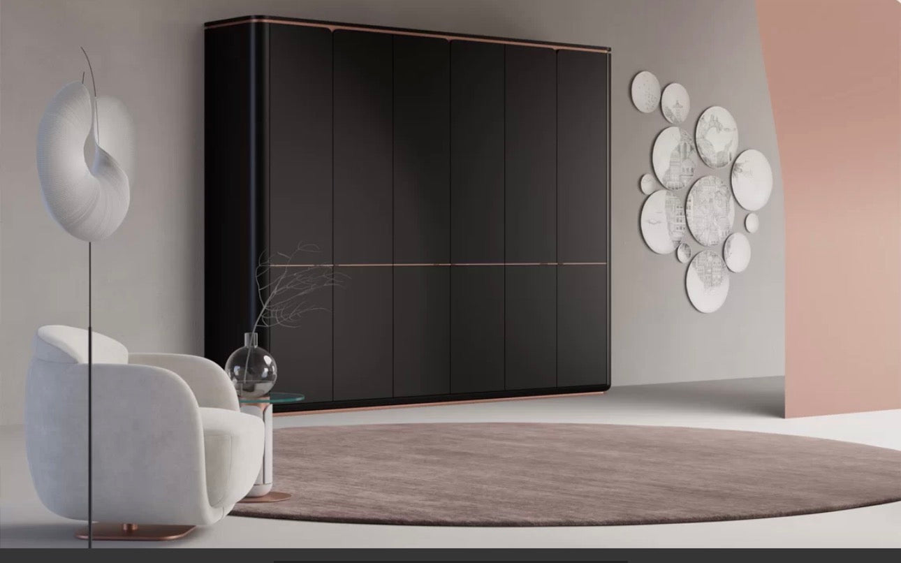 Petale luxury bedroom furniture collection with curved upholstered bed, sculptural nightstands, and dark lacquer wardrobe with rose-gold accents.