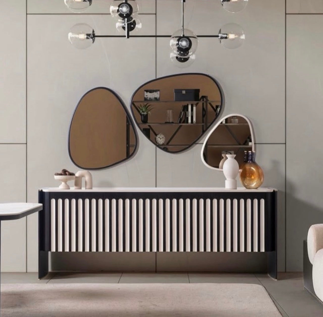 Reverie luxury furniture collection featuring sculptural sofa seating, zebra patterned accent chairs, modern dining table, and contemporary living room design.