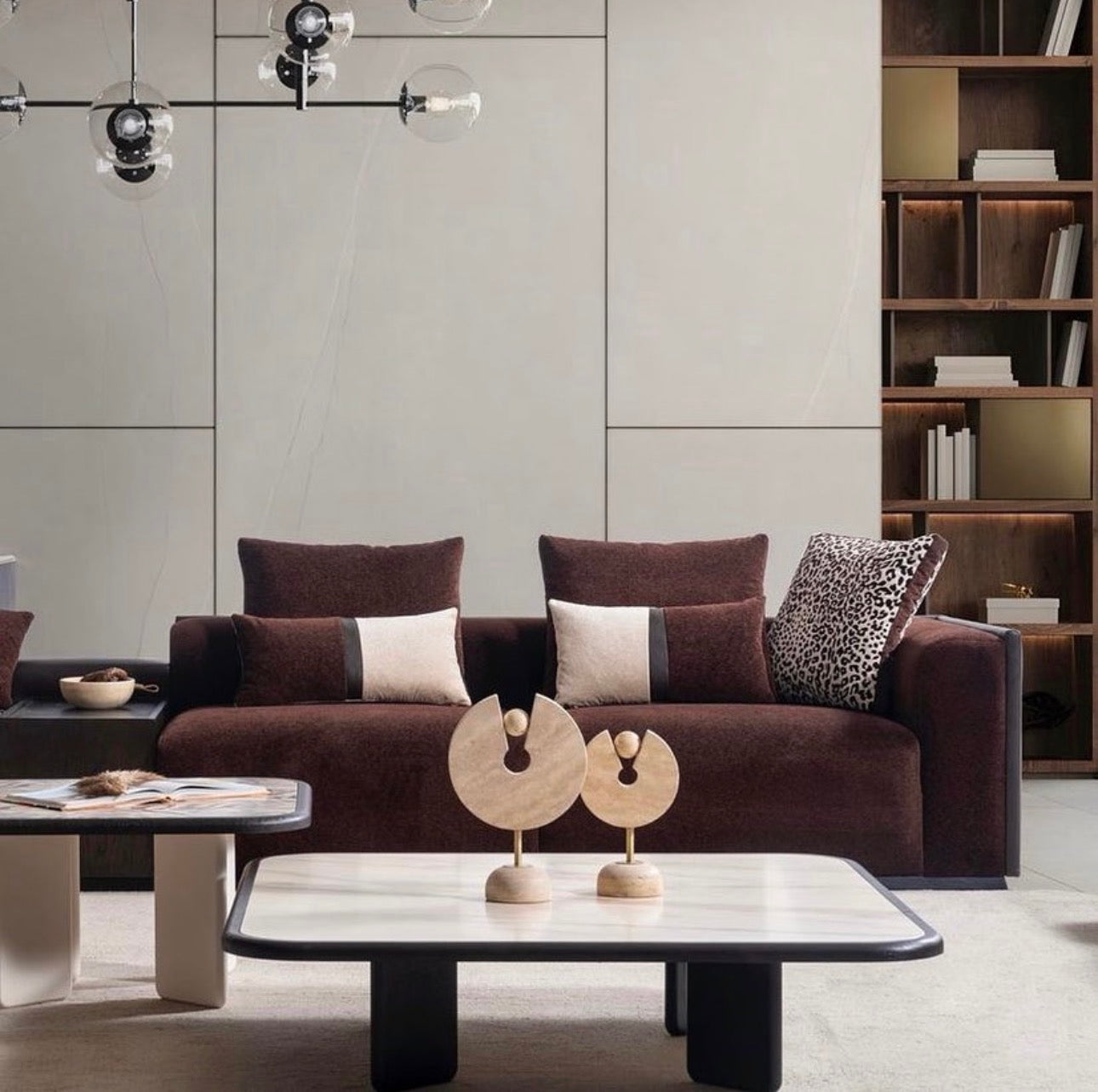 Reverie luxury furniture collection featuring sculptural sofa seating, zebra patterned accent chairs, modern dining table, and contemporary living room design.