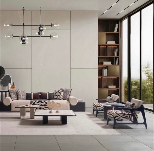 Reverie luxury furniture collection featuring sculptural sofa seating, zebra patterned accent chairs, modern dining table, and contemporary living room design.