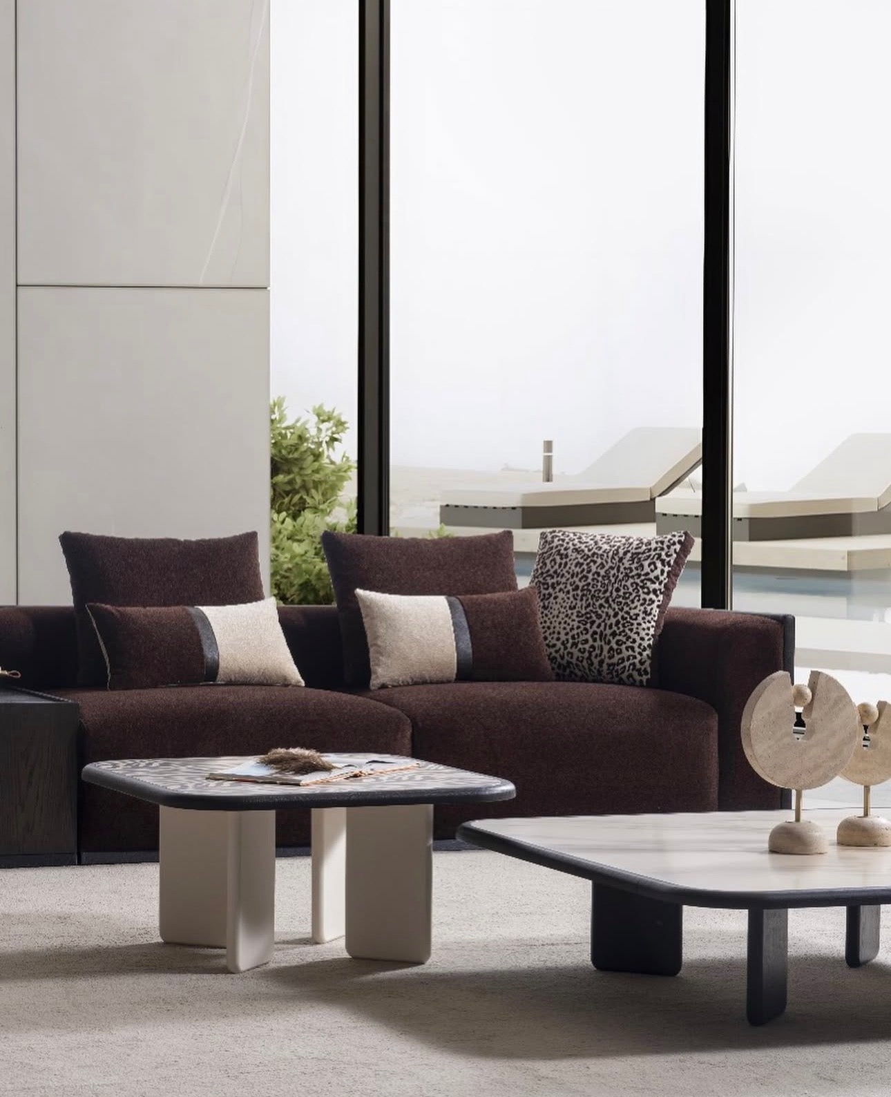Reverie luxury furniture collection featuring sculptural sofa seating, zebra patterned accent chairs, modern dining table, and contemporary living room design.