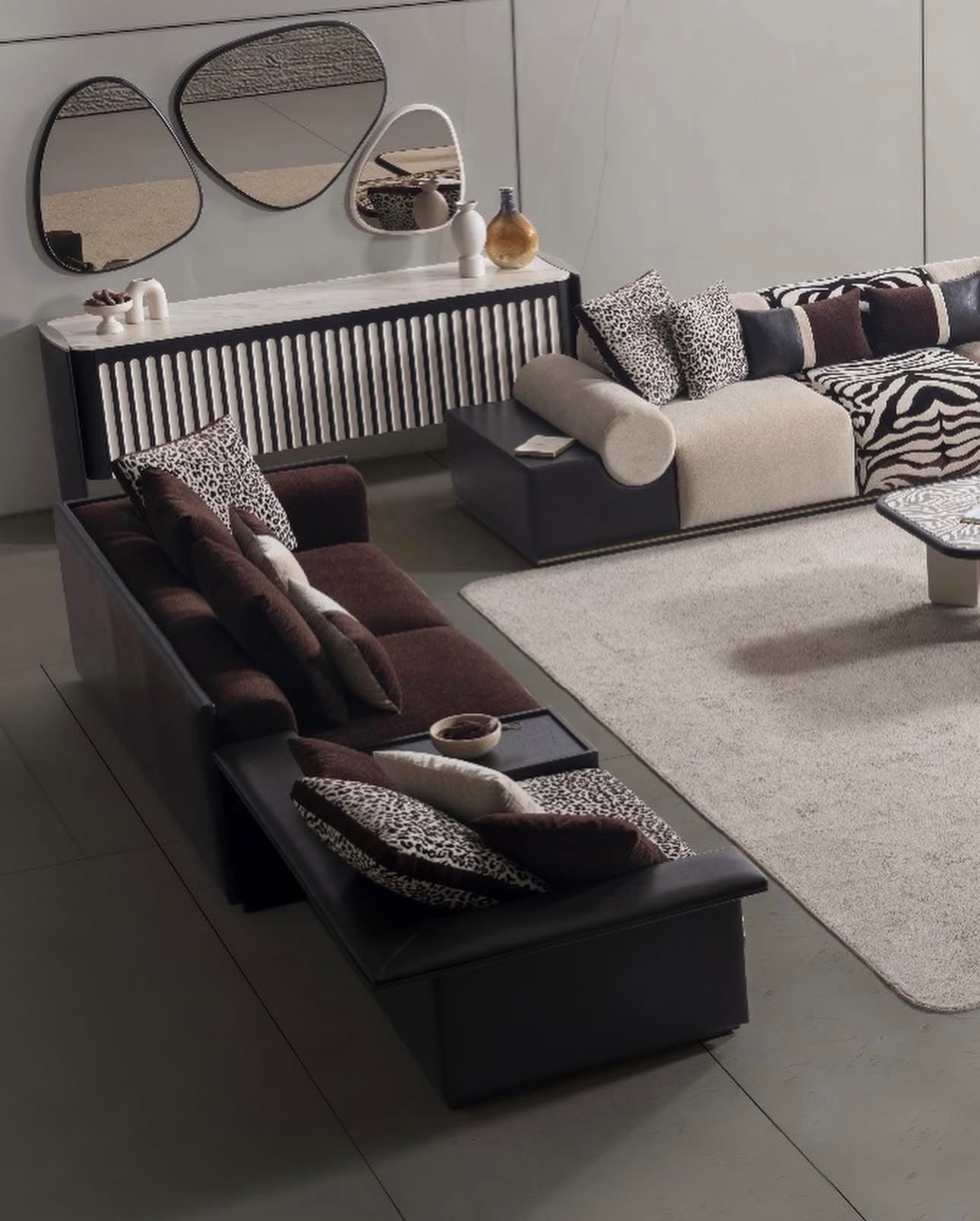 Reverie luxury furniture collection featuring sculptural sofa seating, zebra patterned accent chairs, modern dining table, and contemporary living room design.