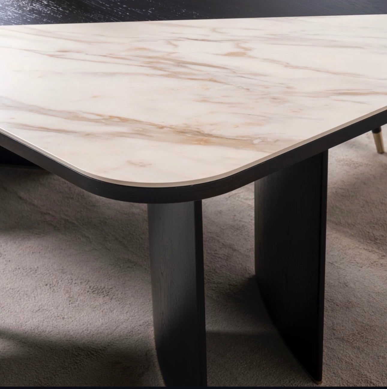 Reverie luxury furniture collection featuring sculptural sofa seating, zebra patterned accent chairs, modern dining table, and contemporary living room design.