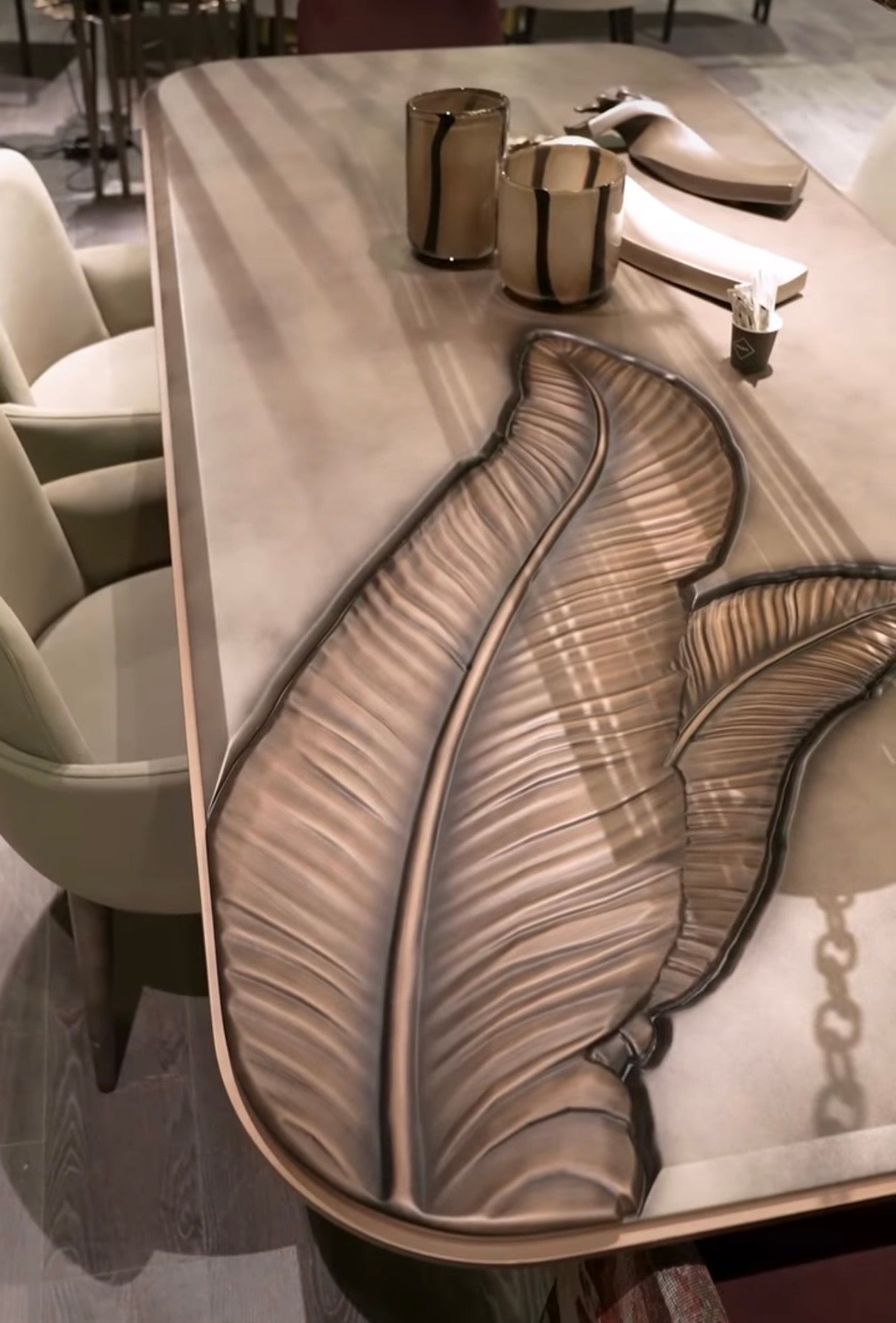 Blush luxury furniture collection featuring sculptural sofa, bronze leaf coffee table, modern dining set, and warm contemporary living room design.