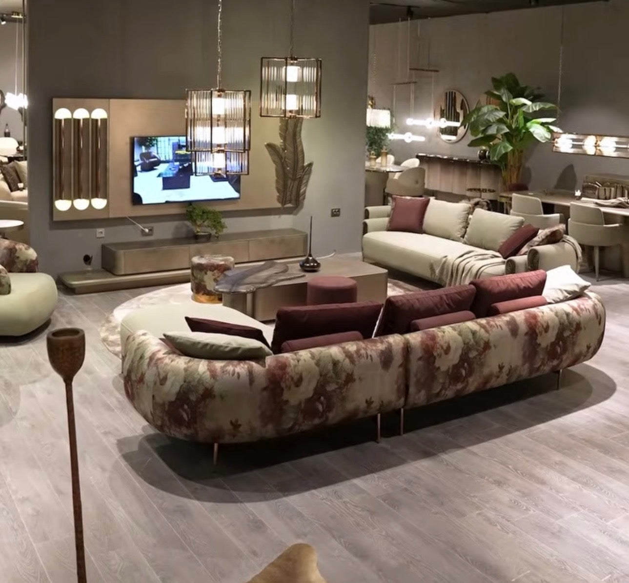 Blush luxury furniture collection featuring sculptural sofa, bronze leaf coffee table, modern dining set, and warm contemporary living room design.