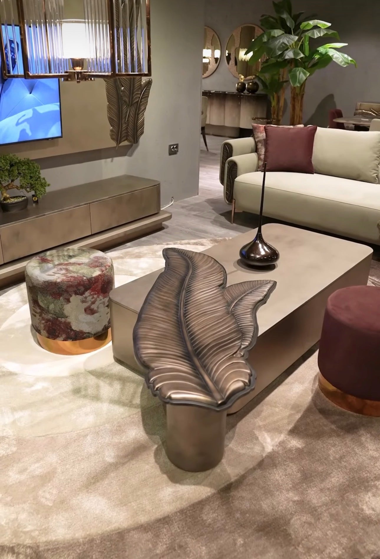 Blush luxury furniture collection featuring sculptural sofa, bronze leaf coffee table, modern dining set, and warm contemporary living room design.