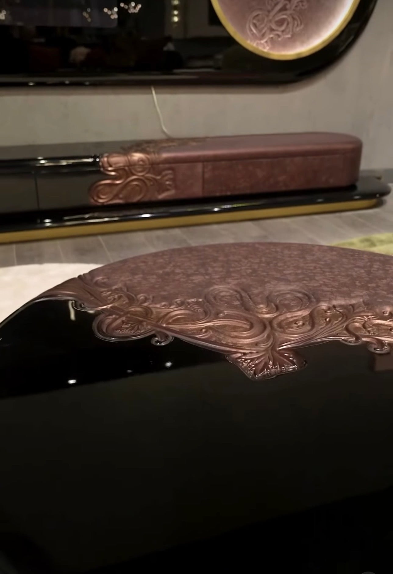 Noir luxury furniture collection with black velvet sofas, copper dining table, sculptural lighting, and dramatic modern interior styling.