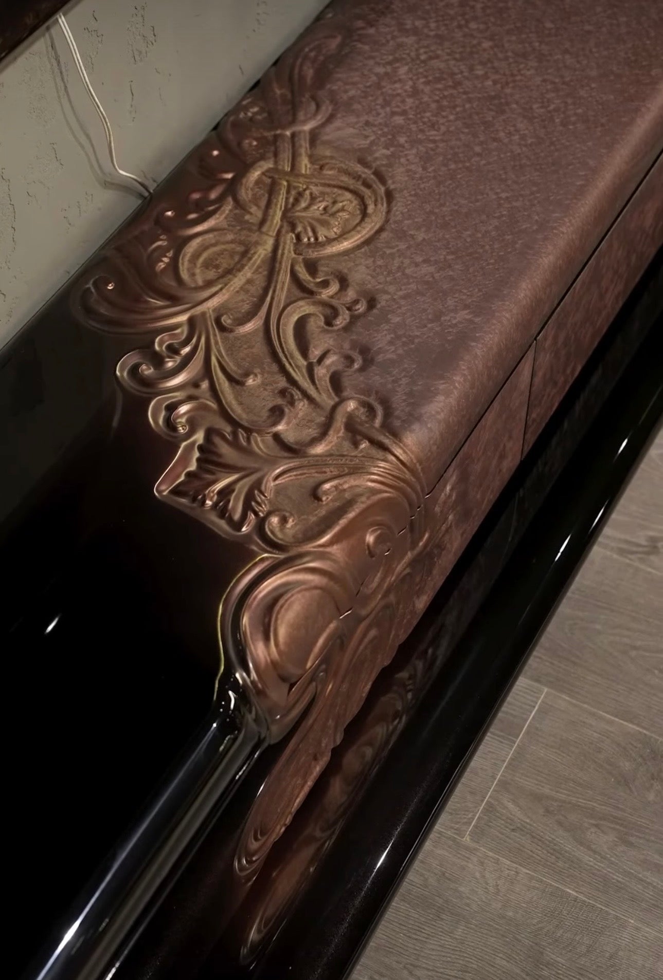 Noir luxury furniture collection with black velvet sofas, copper dining table, sculptural lighting, and dramatic modern interior styling.