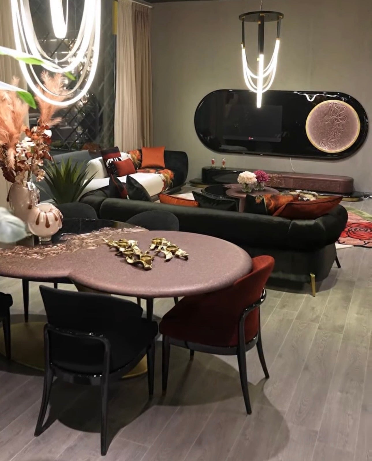 Noir luxury furniture collection with black velvet sofas, copper dining table, sculptural lighting, and dramatic modern interior styling.