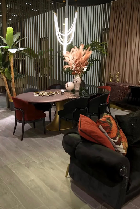 Noir luxury furniture collection with black velvet sofas, copper dining table, sculptural lighting, and dramatic modern interior styling.