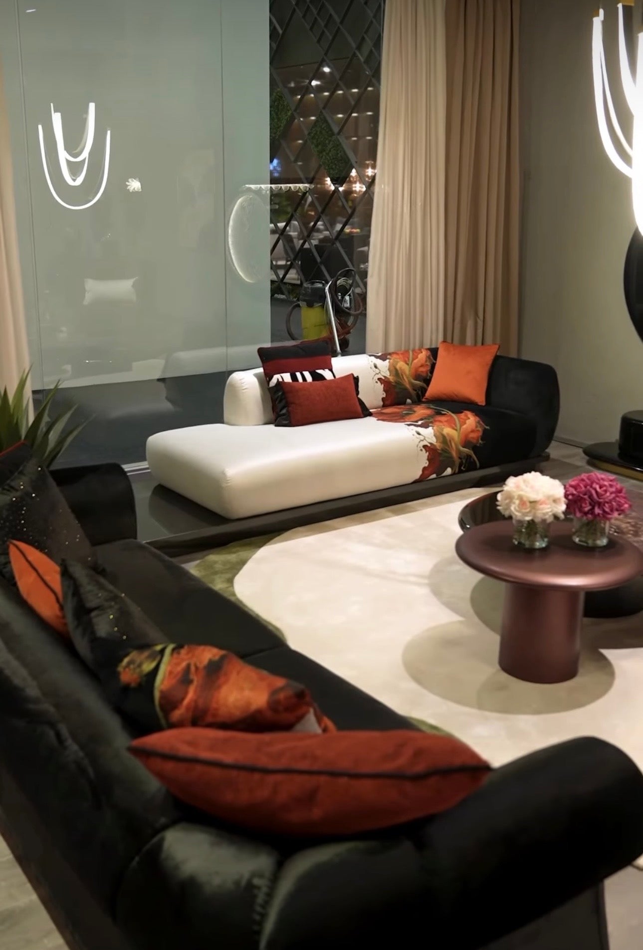 Noir luxury furniture collection with black velvet sofas, copper dining table, sculptural lighting, and dramatic modern interior styling.