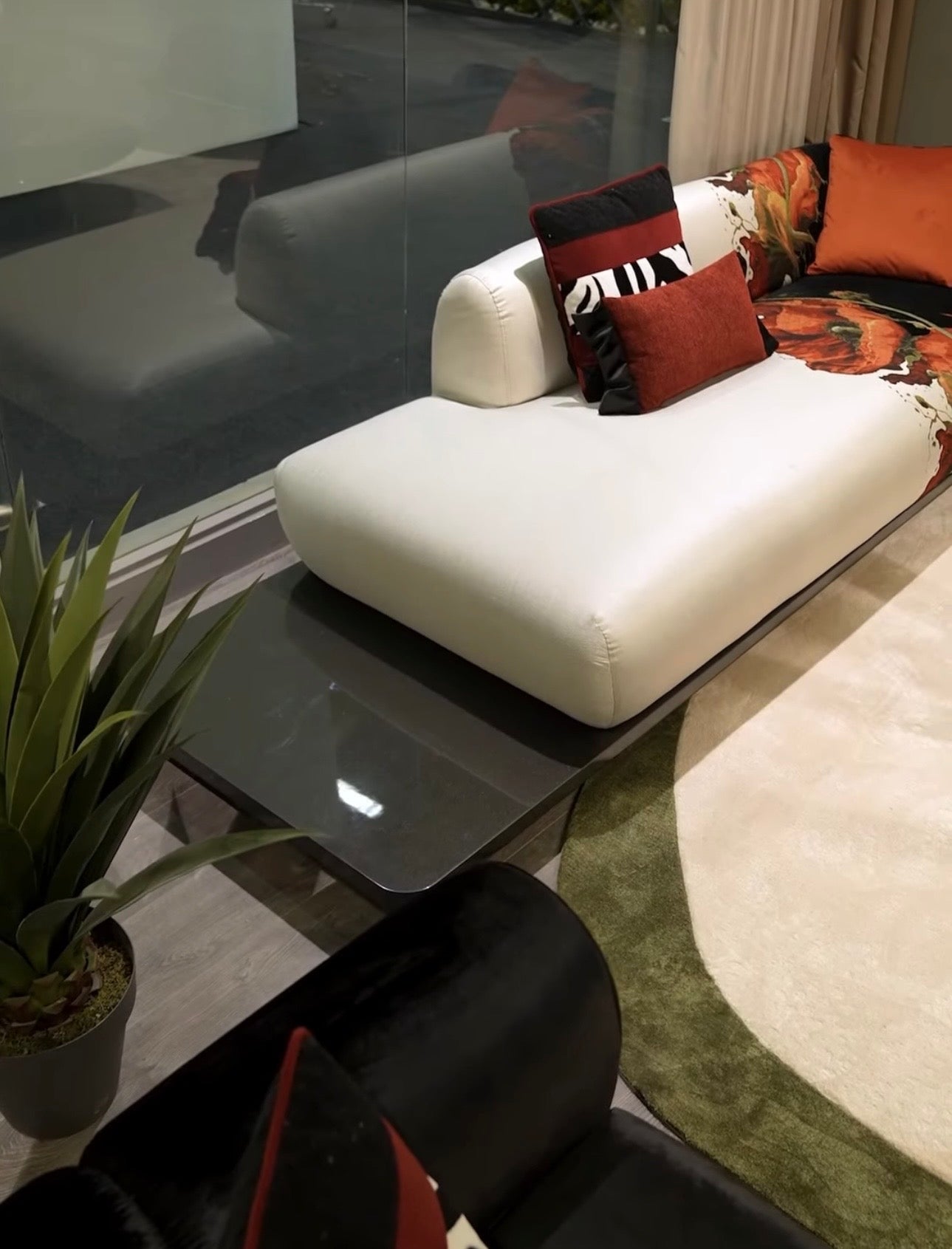 Noir luxury furniture collection with black velvet sofas, copper dining table, sculptural lighting, and dramatic modern interior styling.