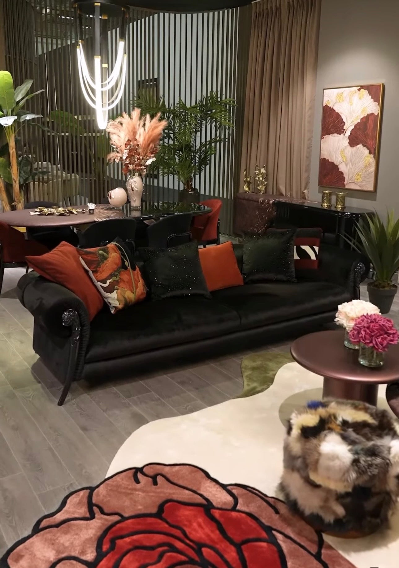 Noir luxury furniture collection with black velvet sofas, copper dining table, sculptural lighting, and dramatic modern interior styling.