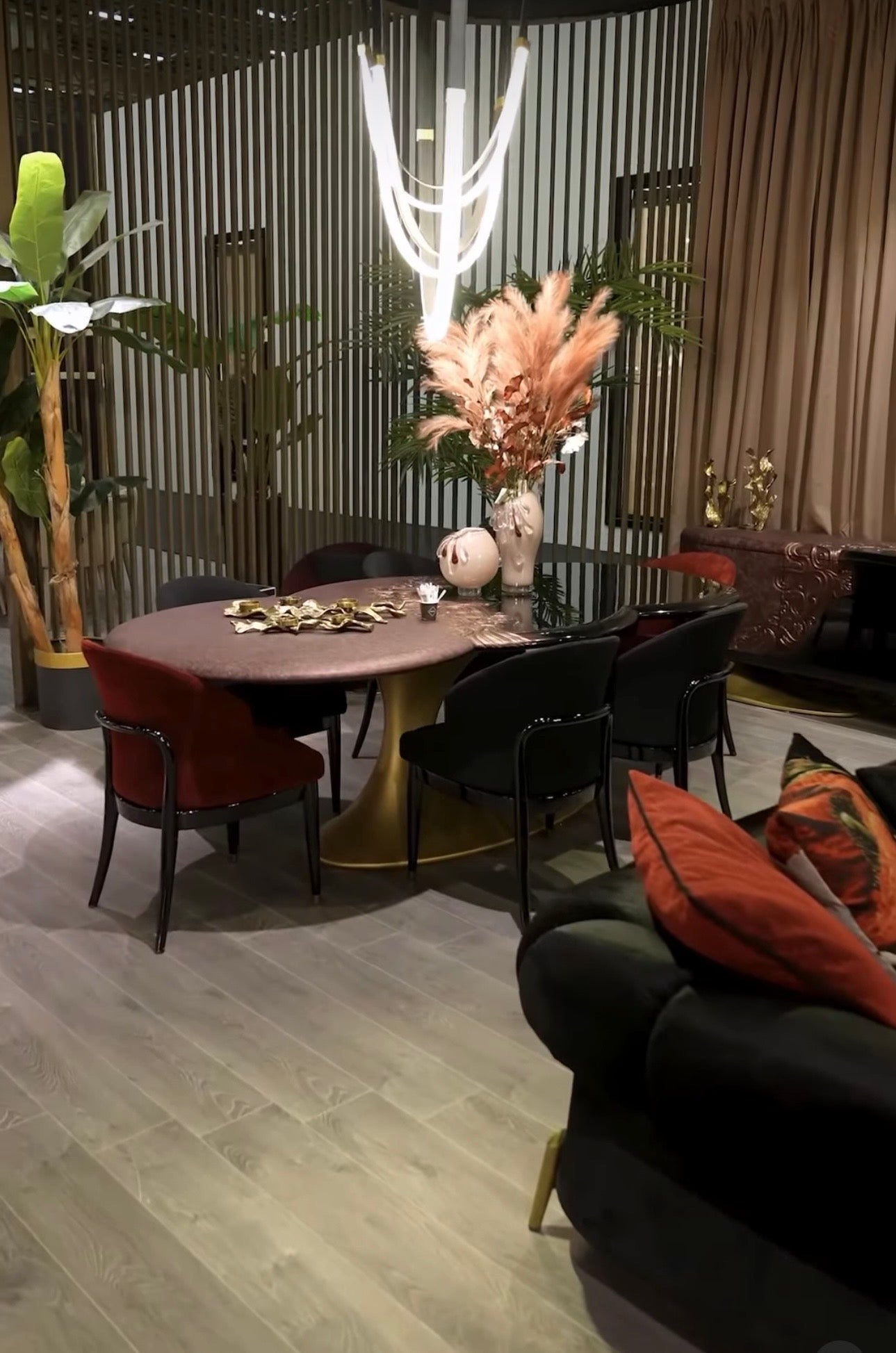 Noir luxury furniture collection with black velvet sofas, copper dining table, sculptural lighting, and dramatic modern interior styling.