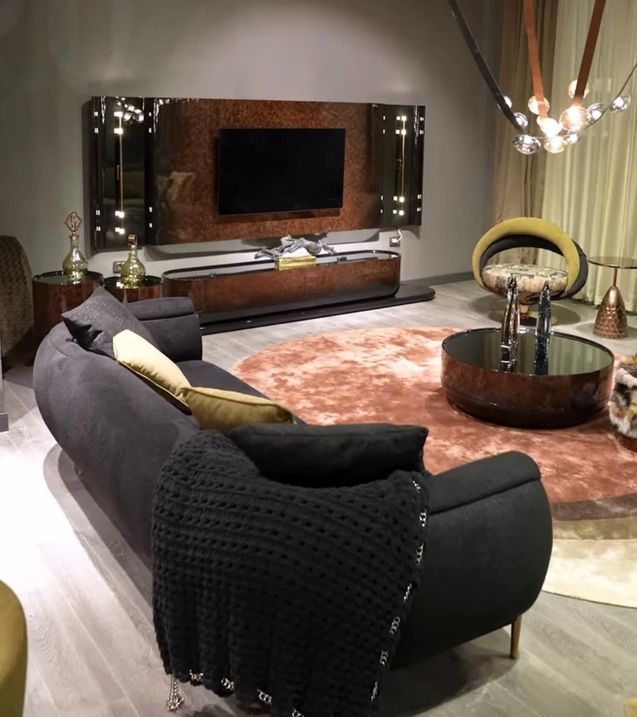 Inferno luxury furniture collection with curved sectional sofa, sculptural dining table, and artistic patterned upholstery.