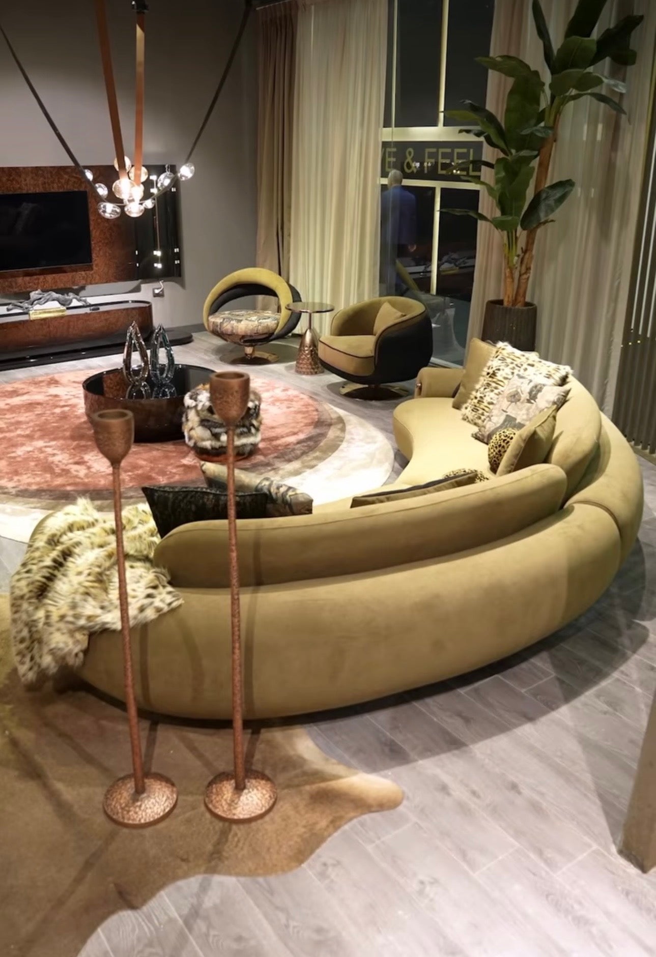 Inferno luxury furniture collection with curved sectional sofa, sculptural dining table, and artistic patterned upholstery.