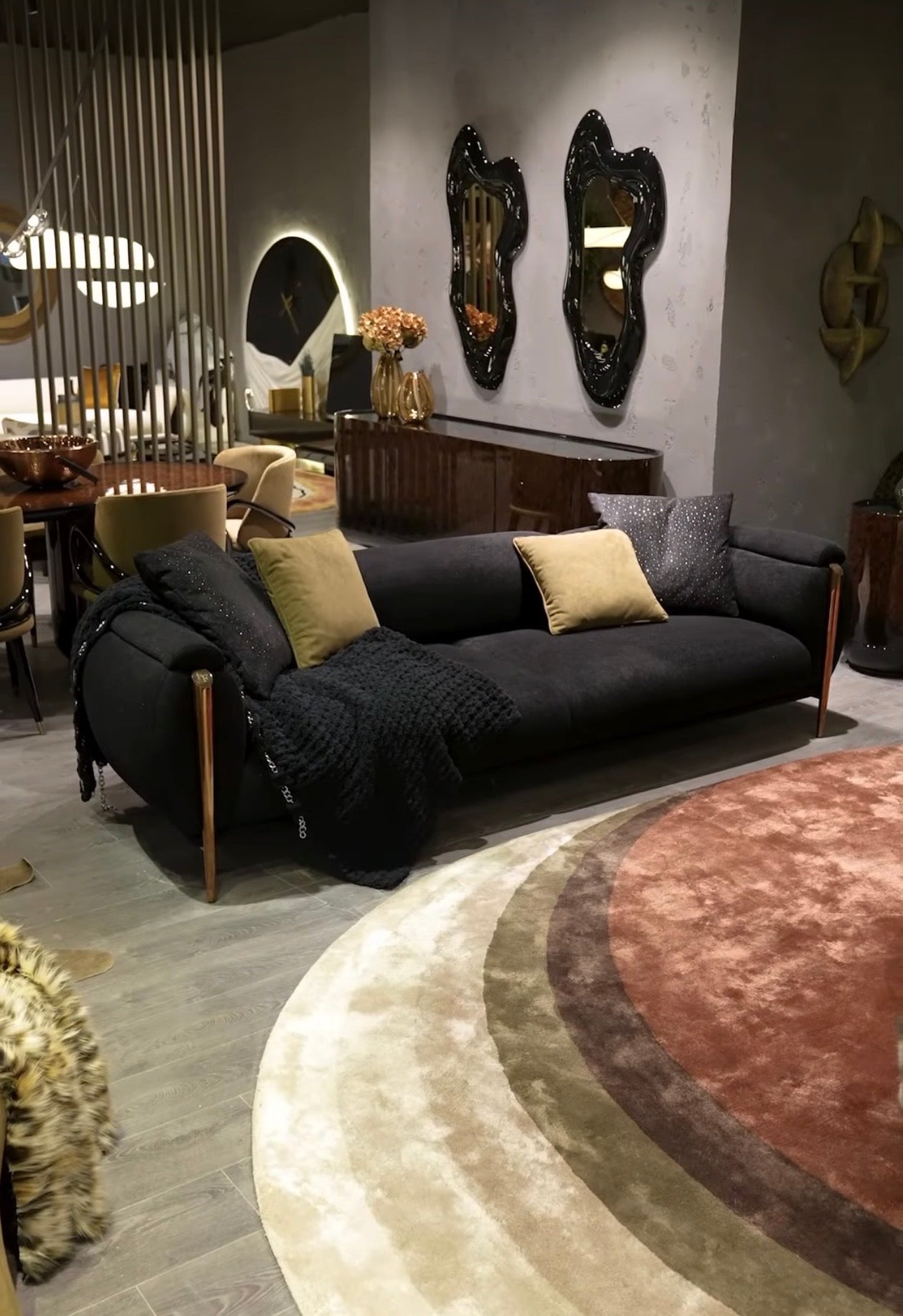 Inferno luxury furniture collection with curved sectional sofa, sculptural dining table, and artistic patterned upholstery.