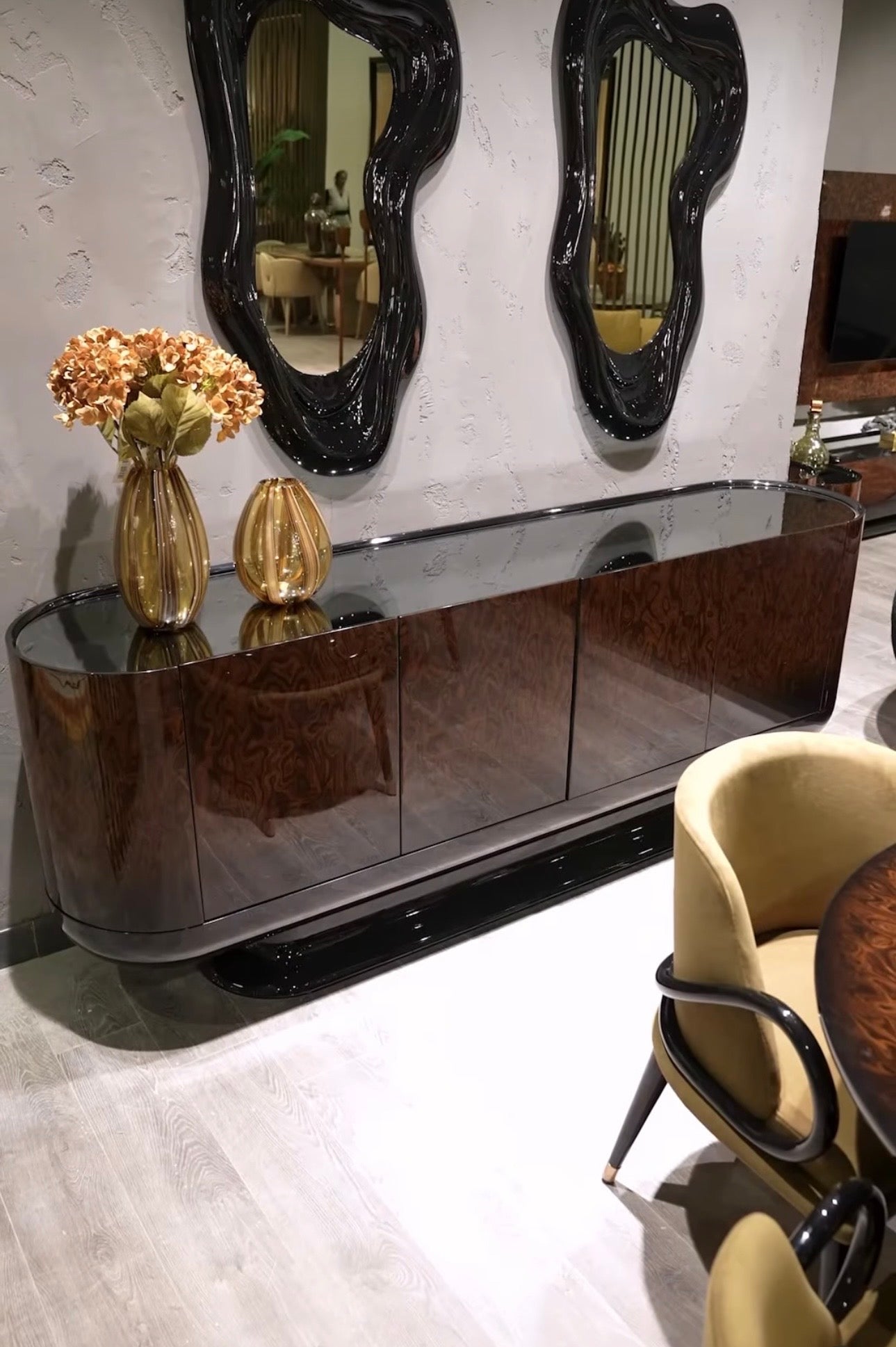 Inferno luxury furniture collection with curved sectional sofa, sculptural dining table, and artistic patterned upholstery.