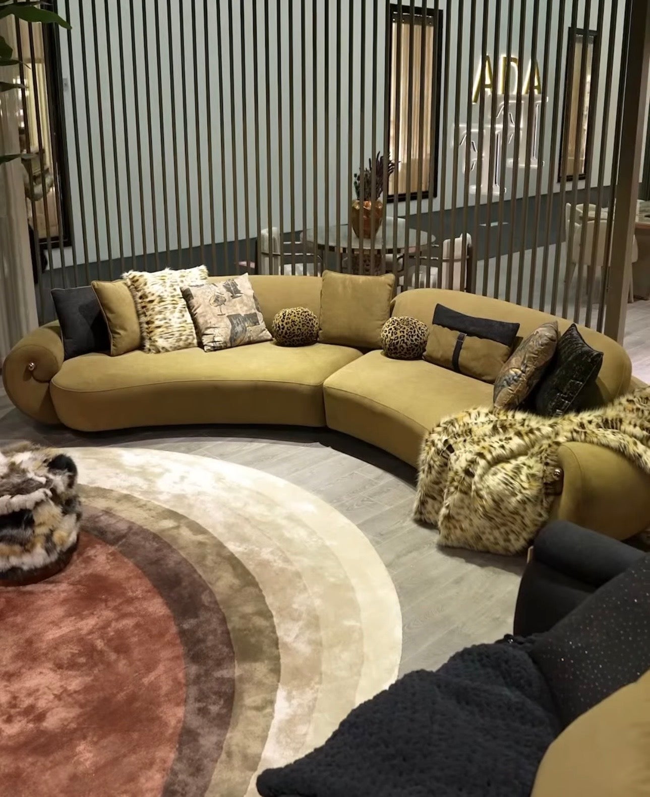 Inferno luxury furniture collection with curved sectional sofa, sculptural dining table, and artistic patterned upholstery.