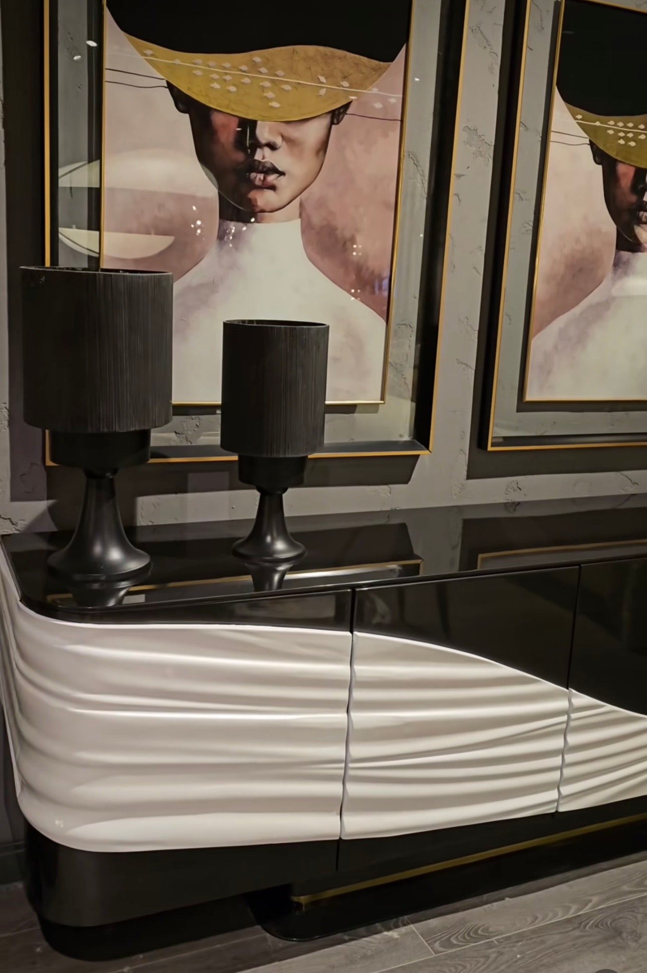 Monochrome modern luxury furniture collection featuring ivory curved sofa, black lacquer tables, and gold accent dining furniture.