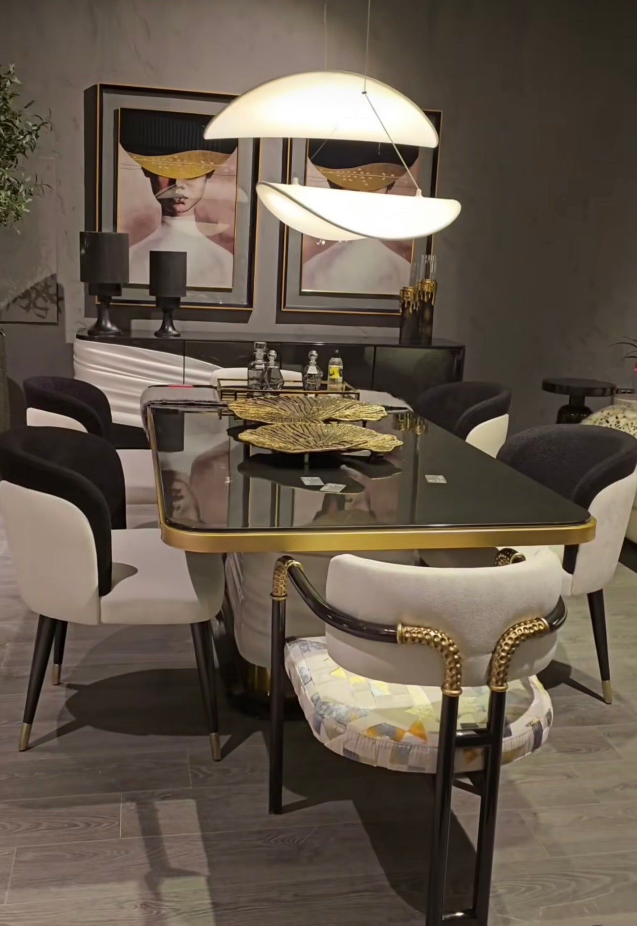 Monochrome modern luxury furniture collection featuring ivory curved sofa, black lacquer tables, and gold accent dining furniture.