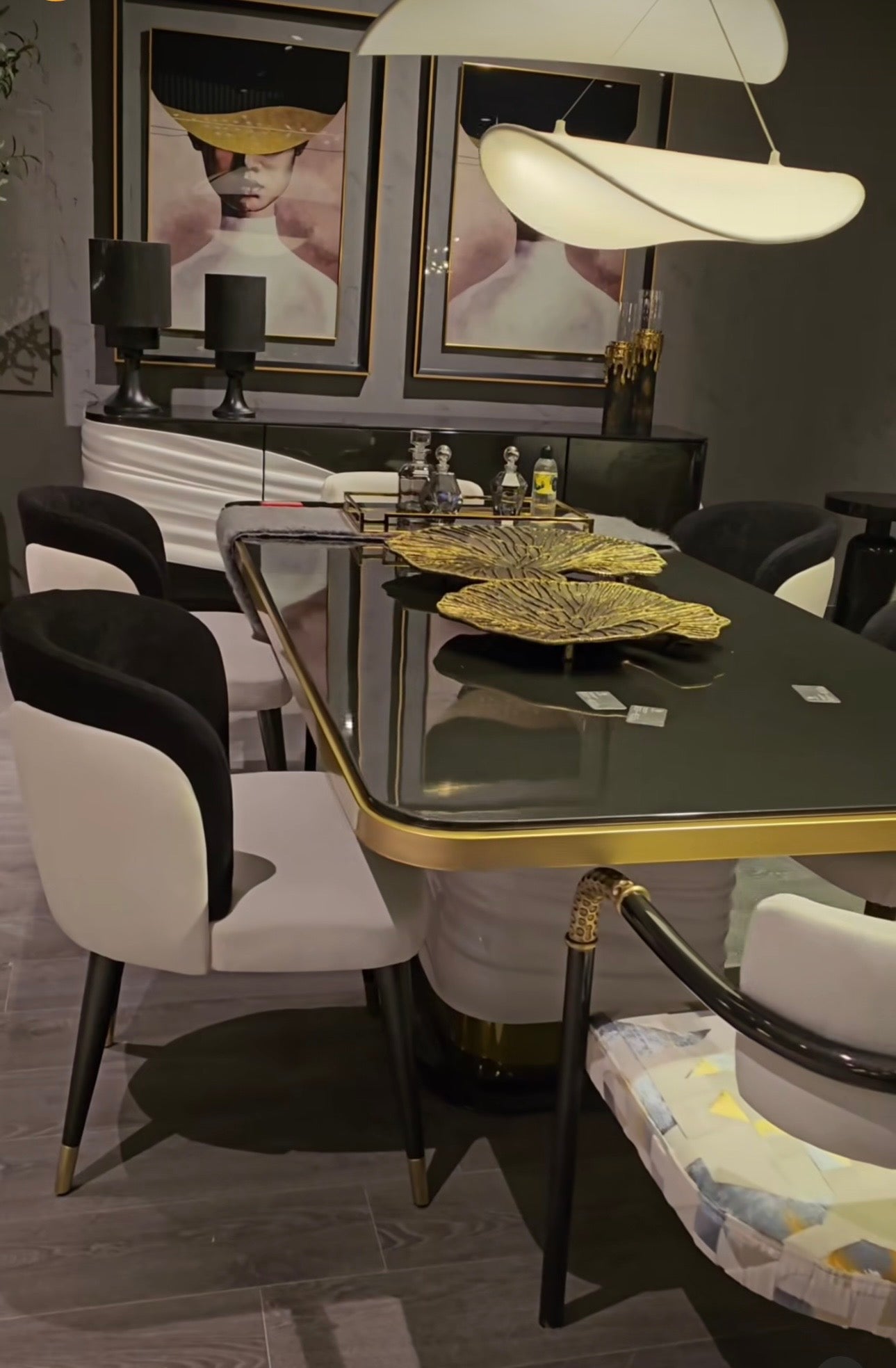 Monochrome modern luxury furniture collection featuring ivory curved sofa, black lacquer tables, and gold accent dining furniture.