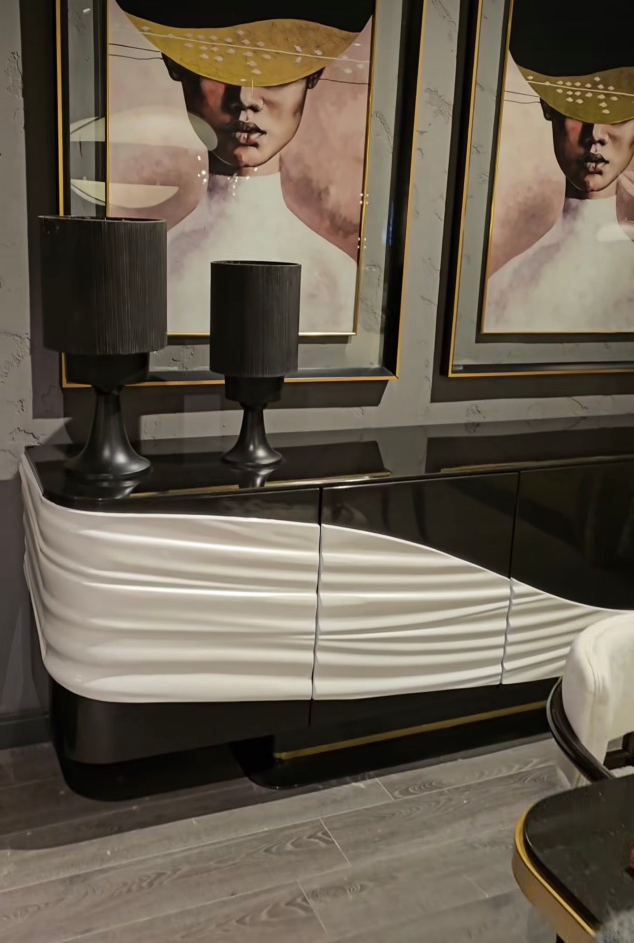 Monochrome modern luxury furniture collection featuring ivory curved sofa, black lacquer tables, and gold accent dining furniture.