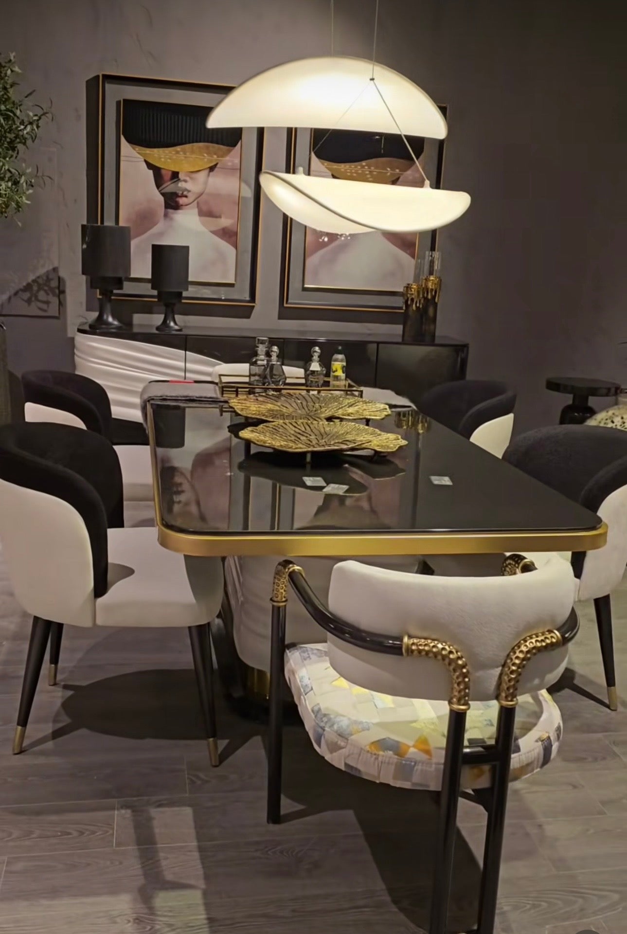 Monochrome modern luxury furniture collection featuring ivory curved sofa, black lacquer tables, and gold accent dining furniture.