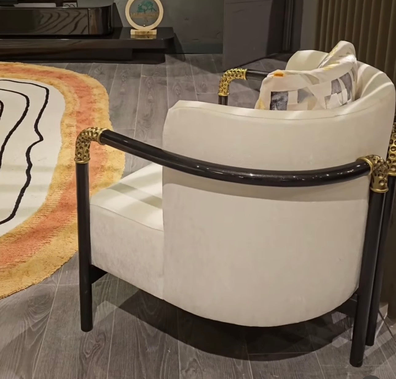 Monochrome modern luxury furniture collection featuring ivory curved sofa, black lacquer tables, and gold accent dining furniture.