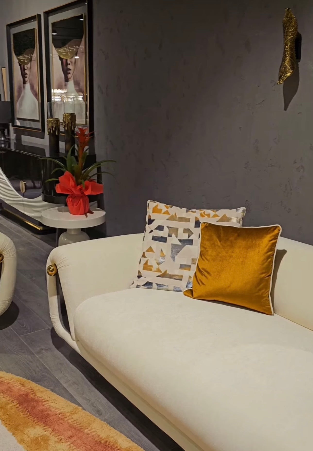 Monochrome modern luxury furniture collection featuring ivory curved sofa, black lacquer tables, and gold accent dining furniture.