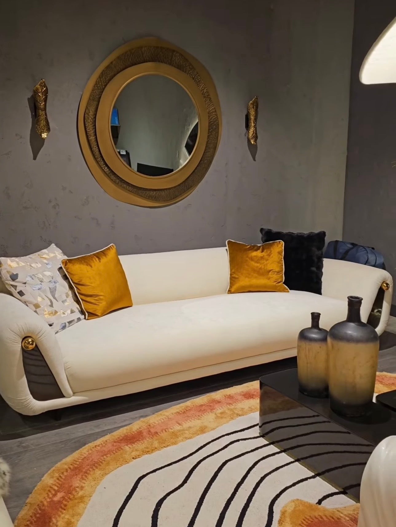 Monochrome modern luxury furniture collection featuring ivory curved sofa, black lacquer tables, and gold accent dining furniture.