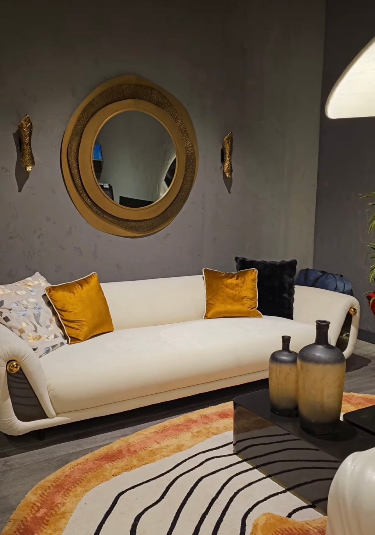 Monochrome modern luxury furniture collection featuring ivory curved sofa, black lacquer tables, and gold accent dining furniture.