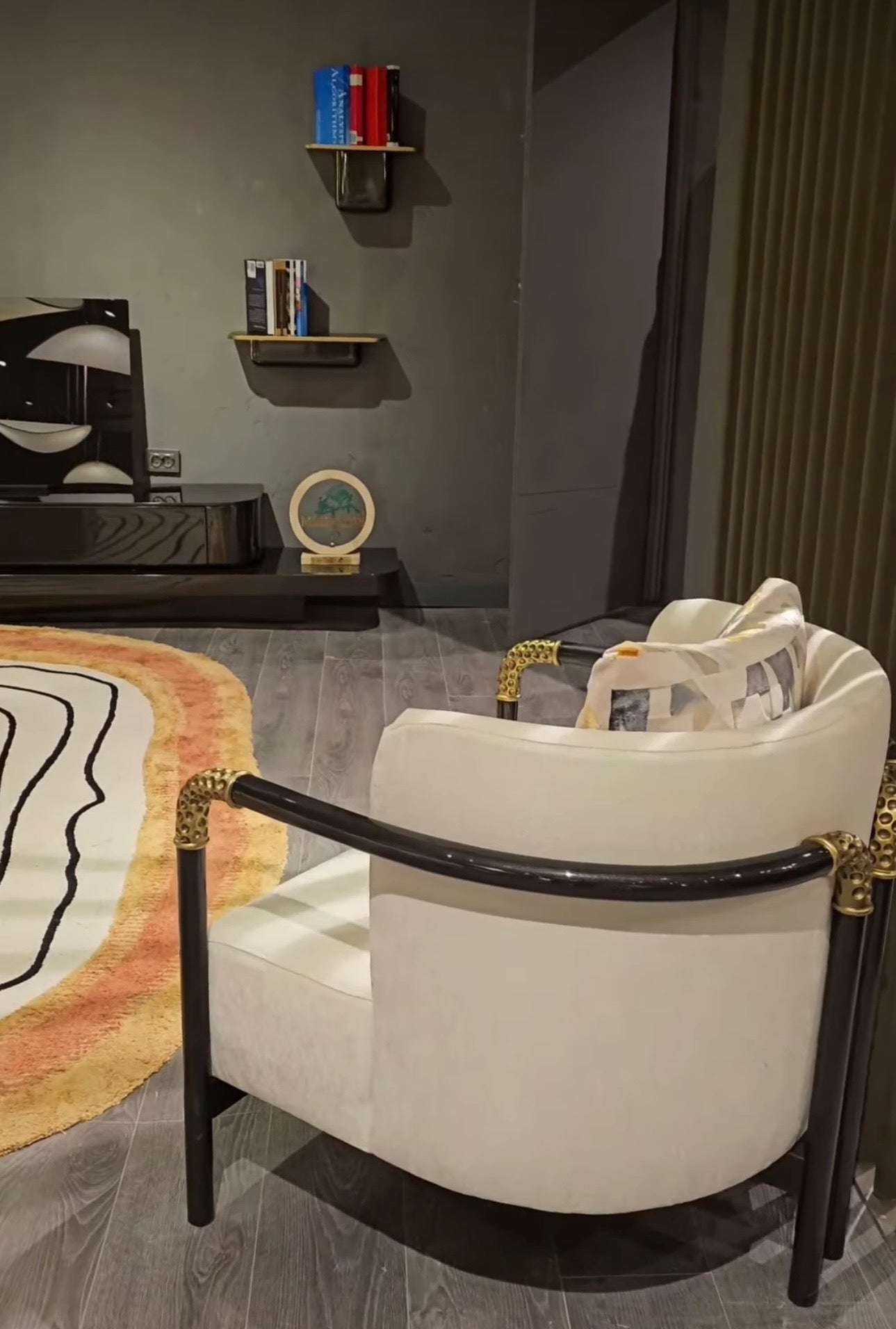 Monochrome modern luxury furniture collection featuring ivory curved sofa, black lacquer tables, and gold accent dining furniture.