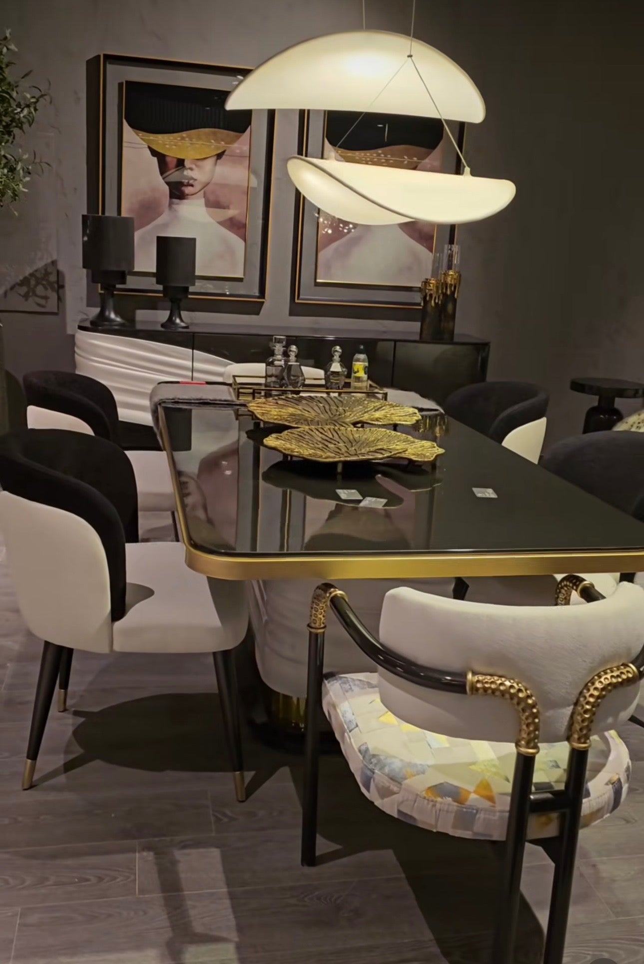 Monochrome modern luxury furniture collection featuring ivory curved sofa, black lacquer tables, and gold accent dining furniture.