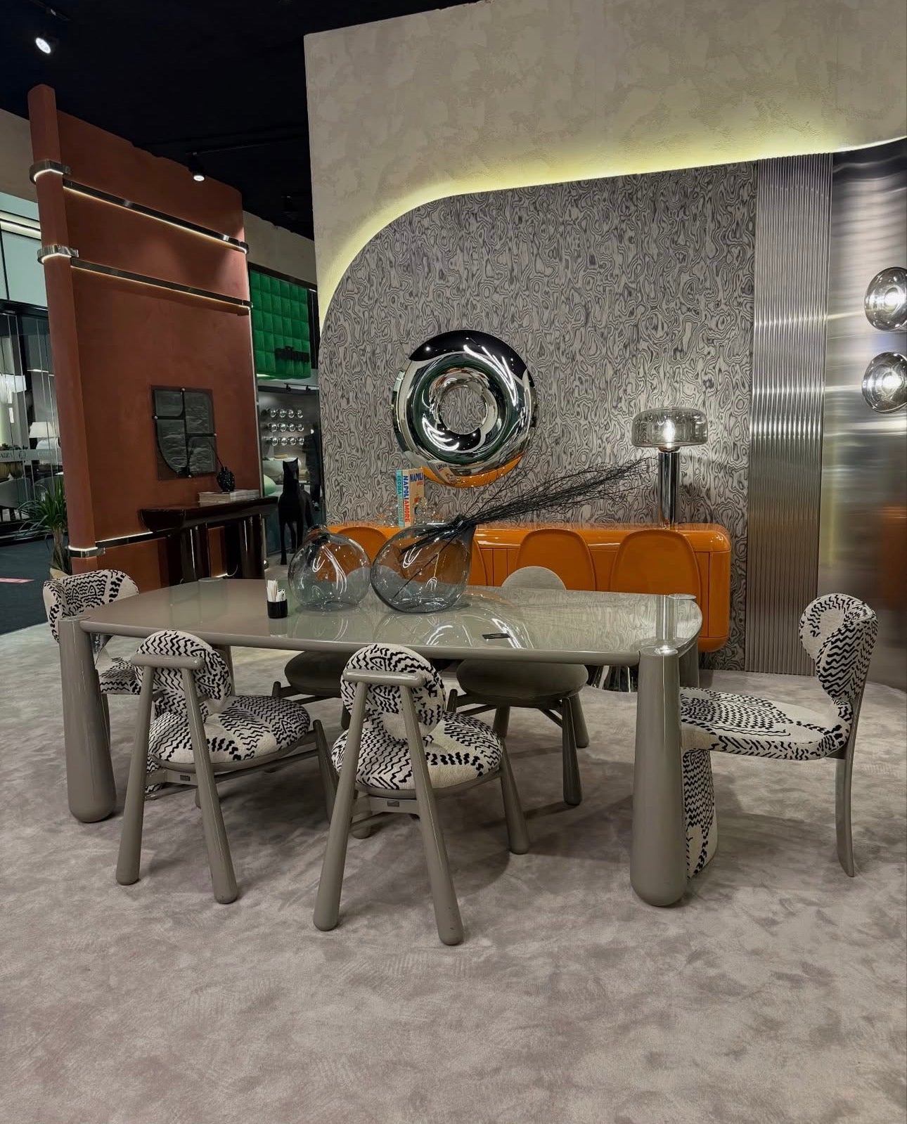 Lowlight modern lacquer furniture collection with sculptural orange sideboard, statement coffee tables, and contemporary dining design.