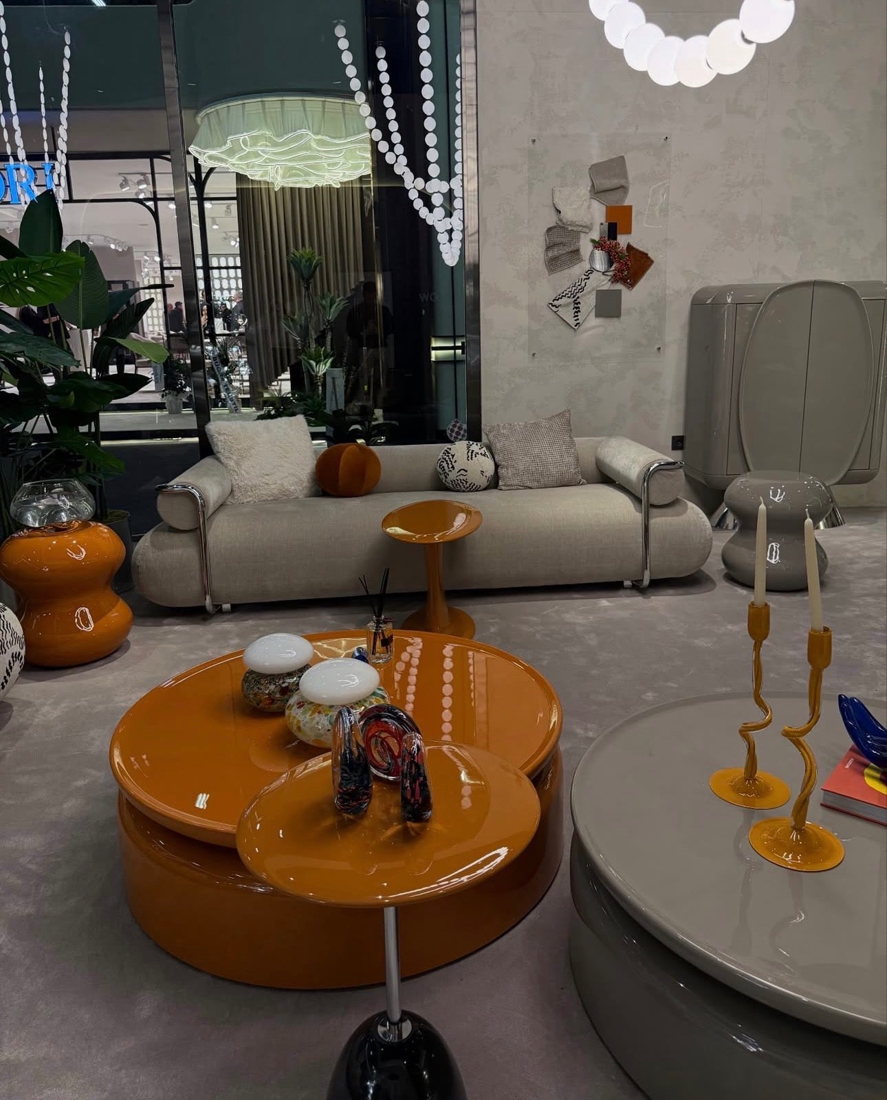 Lowlight modern lacquer furniture collection with sculptural orange sideboard, statement coffee tables, and contemporary dining design.