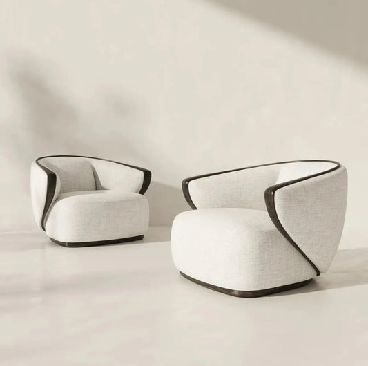 Calm luxury living and dining furniture collection with curved upholstered sofas, dark wood dining table, and elegant sideboard cabinetry.