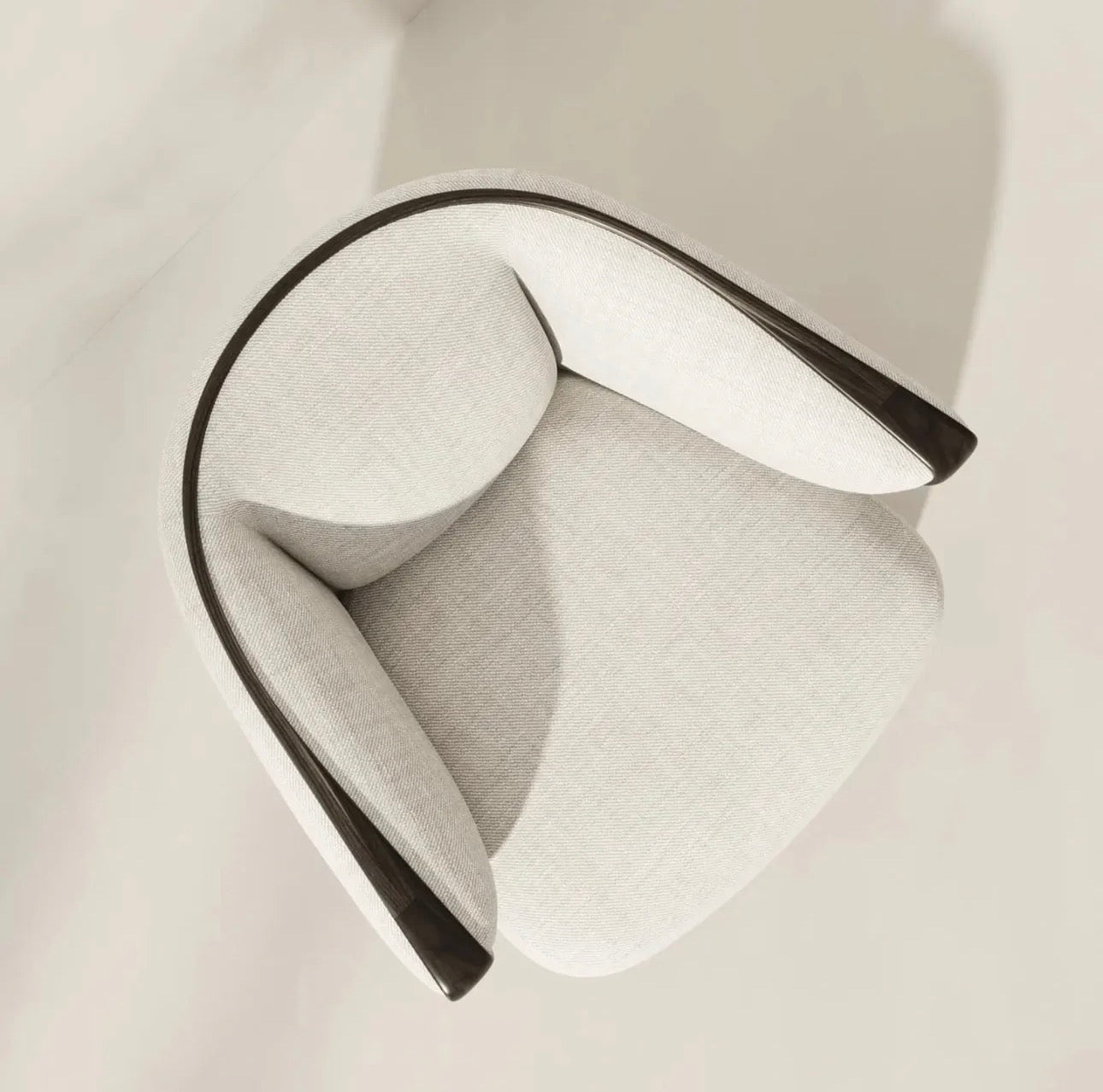 Calm luxury living and dining furniture collection with curved upholstered sofas, dark wood dining table, and elegant sideboard cabinetry.