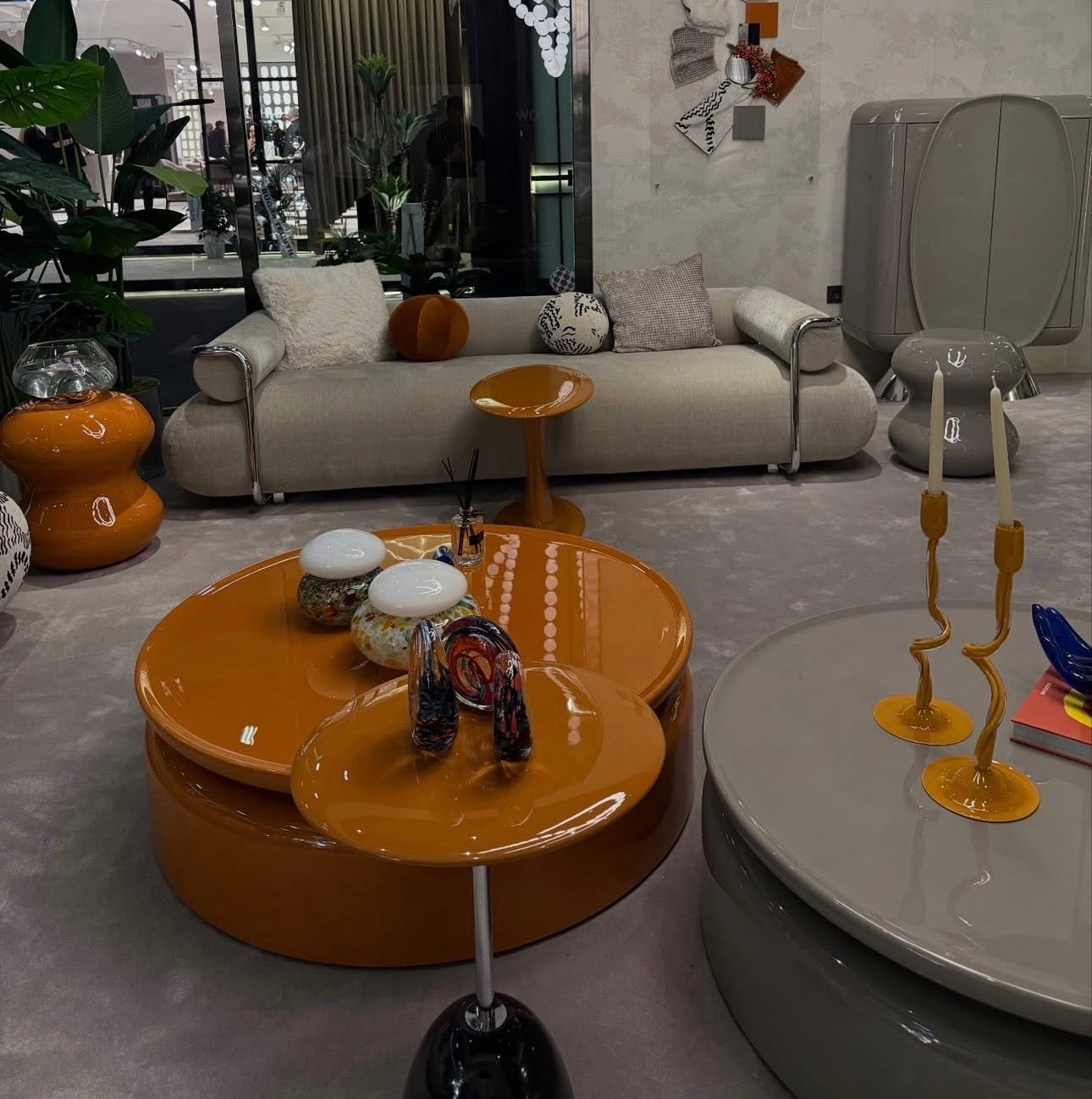 Lowlight modern lacquer furniture collection with sculptural orange sideboard, statement coffee tables, and contemporary dining design.