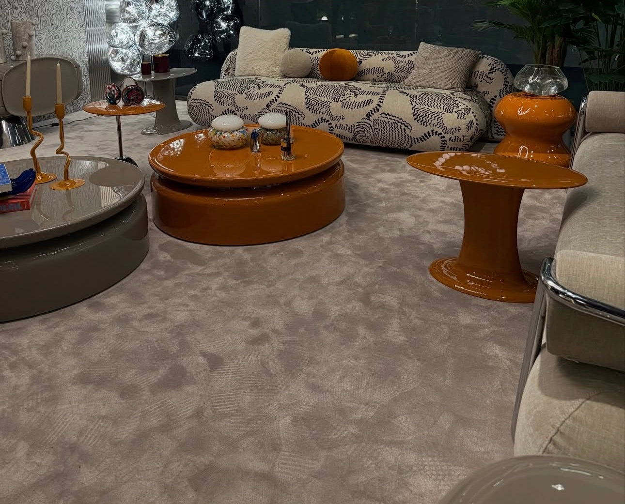 Lowlight modern lacquer furniture collection with sculptural orange sideboard, statement coffee tables, and contemporary dining design.