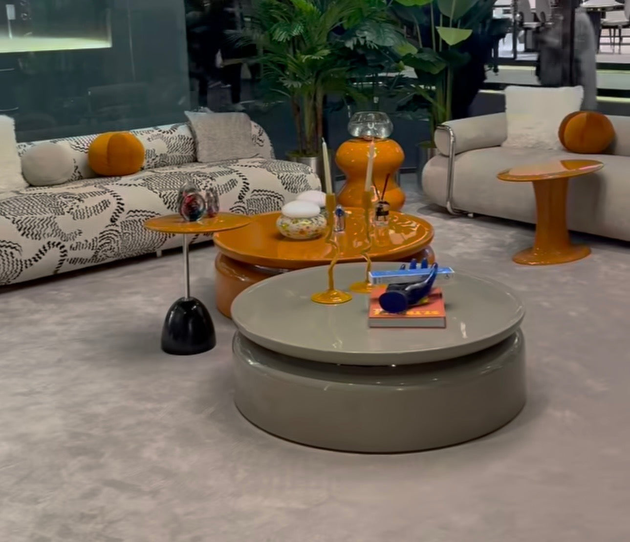 Lowlight modern lacquer furniture collection with sculptural orange sideboard, statement coffee tables, and contemporary dining design.