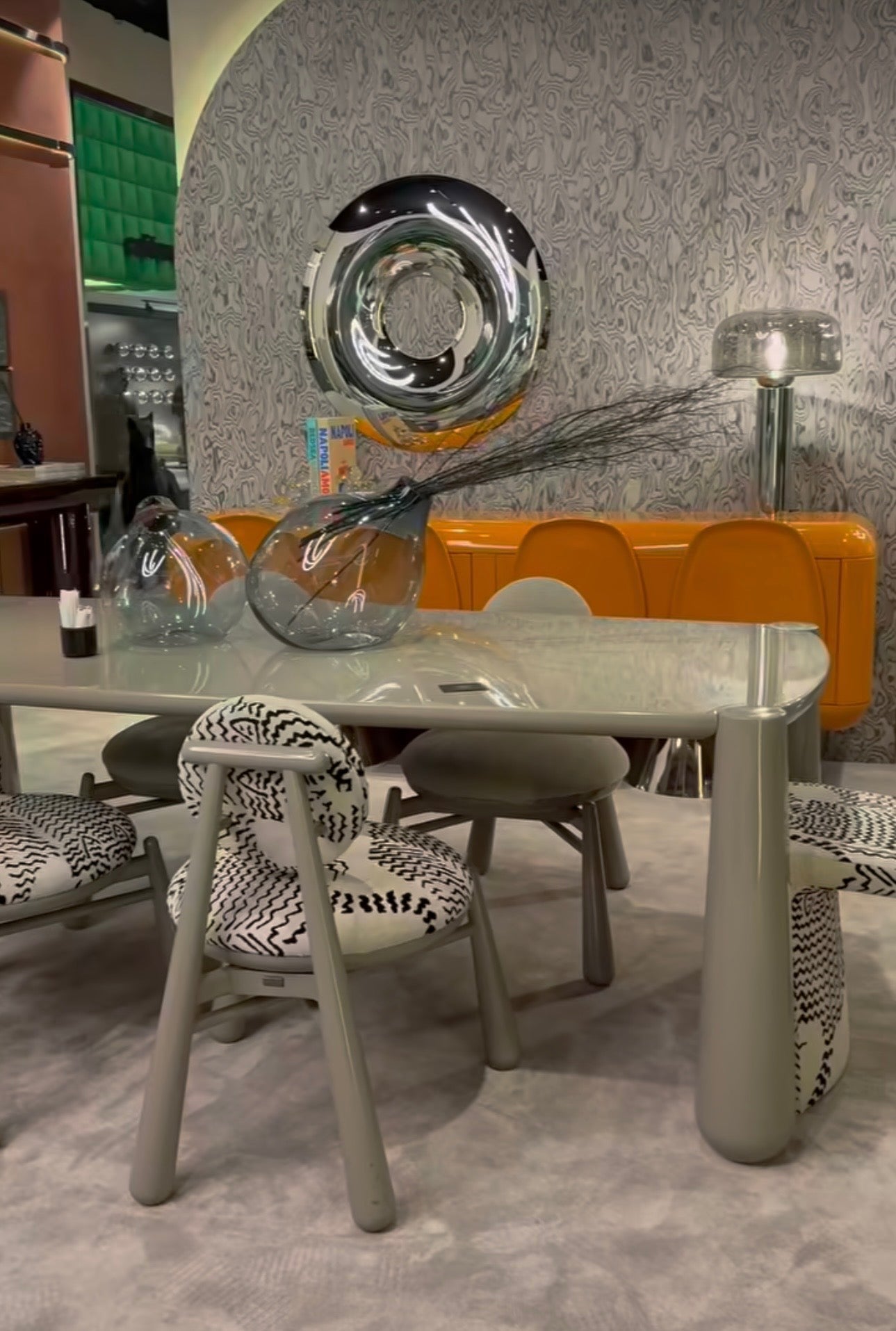 Lowlight modern lacquer furniture collection with sculptural orange sideboard, statement coffee tables, and contemporary dining design.